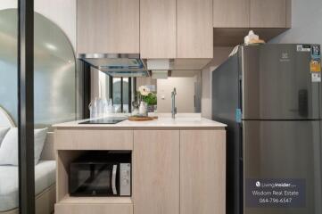 Modern and well-equipped kitchen with wooden cabinets and sleek appliances