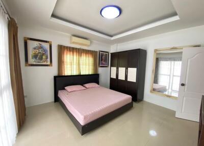 Spacious master bedroom with modern furnishings and ample natural light