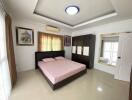 Spacious master bedroom with modern furnishings and ample natural light