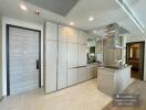 Modern minimalist kitchen with integrated appliances and ample storage