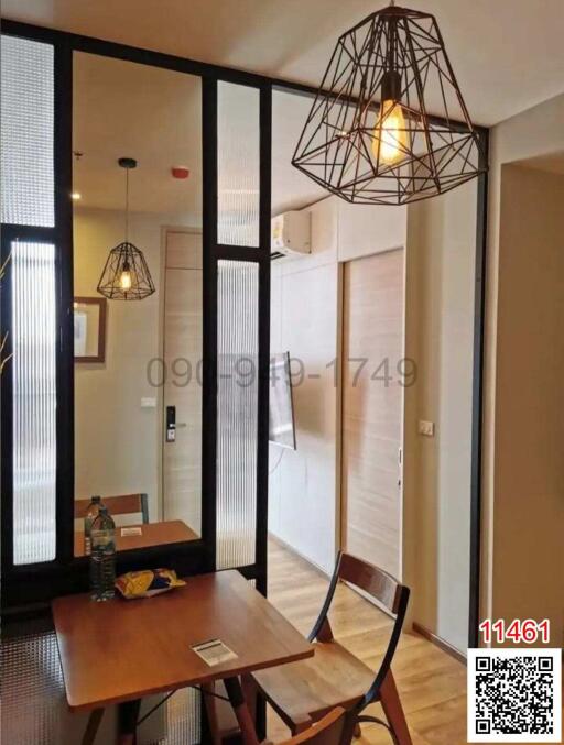 Modern dining area with stylish lighting and glass partition