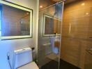 Modern bathroom with glass shower enclosure and sleek toilet