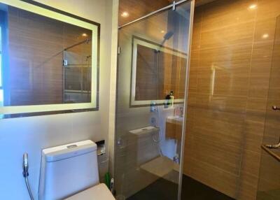 Modern bathroom with glass shower enclosure and sleek toilet
