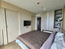 Modern bedroom with wooden wardrobes and flat-screen TV