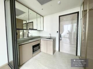 Modern kitchen with built-in appliances and ample natural light