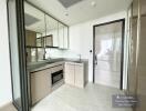 Modern kitchen with built-in appliances and ample natural light