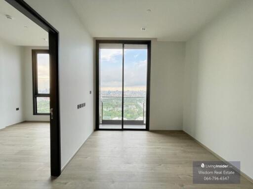 Spacious bedroom with large window and city view