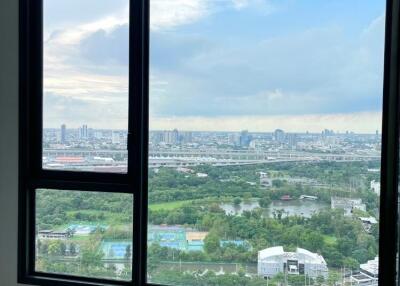 Bedroom with large window overlooking the city