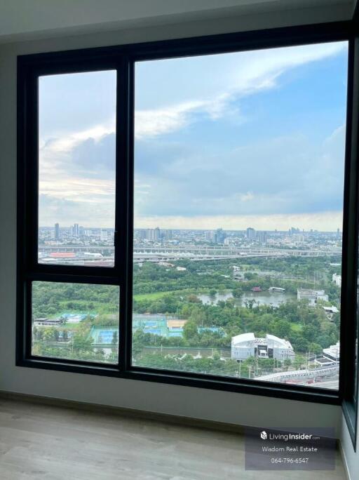 Bedroom with large window overlooking the city