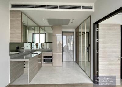 Modern kitchen with reflective surfaces, sleek design, and well-lit interior