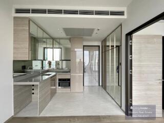 Modern kitchen with reflective surfaces, sleek design, and well-lit interior