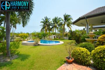Spacious backyard with swimming pool and lush garden