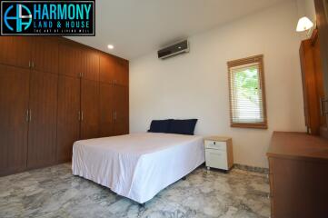 Spacious bedroom with large bed and built-in wardrobes