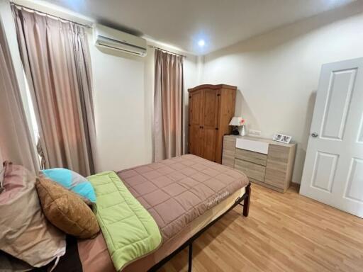 Cozy bedroom with modern amenities and wooden flooring