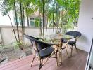 Cozy outdoor patio space with seating and lush greenery