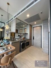 Modern kitchen with integrated dining space and stylish lighting