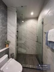 Modern bathroom with glass shower and marble tiles