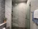 Modern bathroom with glass shower and marble tiles