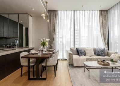 Modern open concept living room with kitchen area, bright and elegantly furnished