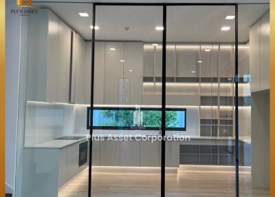 Modern kitchen with glass partition and built-in cabinets
