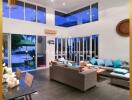 Spacious modern living room with high ceilings and pool view