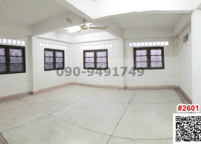 Spacious and well-lit empty living room with multiple windows