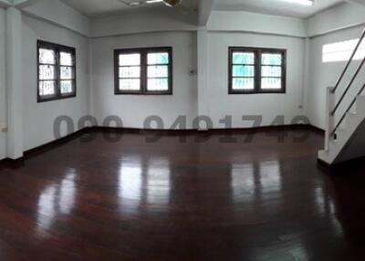 Spacious living room with polished hardwood floors and ample natural light