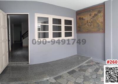 spacious entrance hall with grey walls and tiled floor