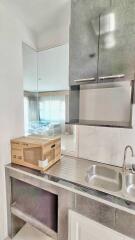 Modern kitchen with stainless steel sink and minimalist cabinets