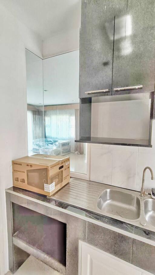 Modern kitchen with stainless steel sink and minimalist cabinets