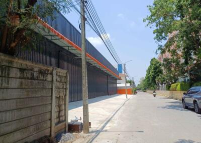 Urban street view with industrial buildings and paved sidewalk