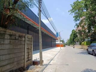 Urban street view with industrial buildings and paved sidewalk