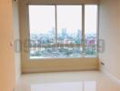 Spacious living room with large window offering city view