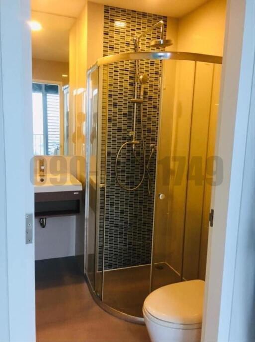 Modern bathroom interior with glass shower and natural lighting