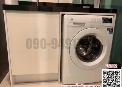 Modern kitchen laundry setup with an integrated washing machine