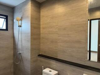 Modern bathroom with neutral tiled walls and high-end fixtures