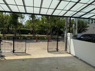 Spacious covered driveway with secure gates