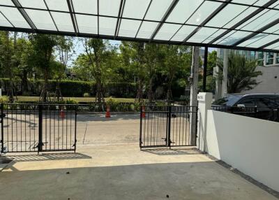 Spacious covered driveway with secure gates
