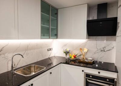 Modern kitchen with marble countertops and built-in appliances