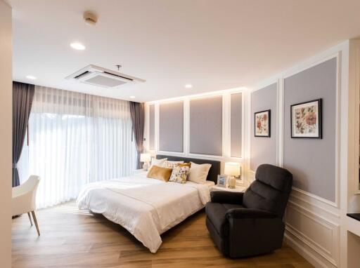 Elegant and well-lit bedroom with contemporary design