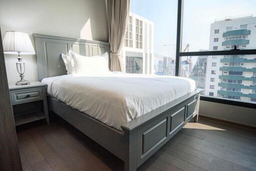 Spacious bedroom with natural light and city view