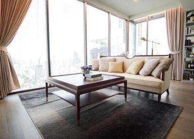 Elegant living room with large windows and city view