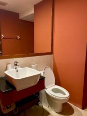 Compact modern bathroom with vibrant red walls
