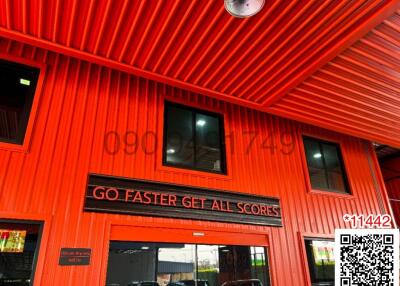 Bright red commercial building exterior with an industrial design