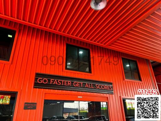 Bright red commercial building exterior with an industrial design