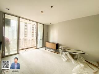 Spacious living room with large windows and balcony