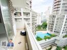 Balcony with high-rise building view and swimming pool