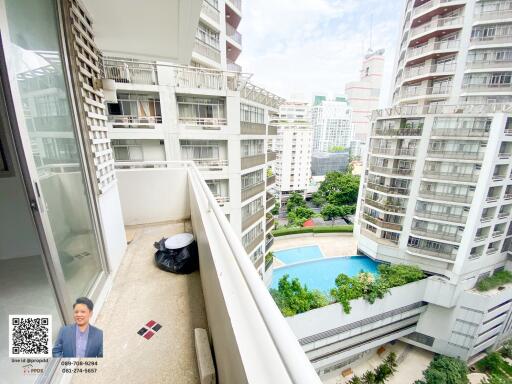 Balcony with high-rise building view and swimming pool