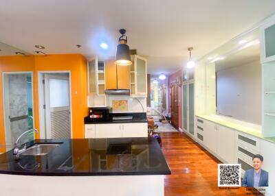 Spacious, well-lit kitchen with modern appliances and vibrant cabinetry