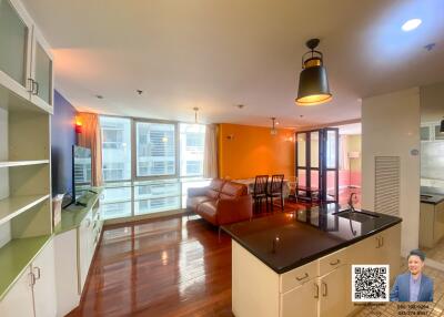 Spacious and brightly lit living room with integrated dining area and modern kitchen